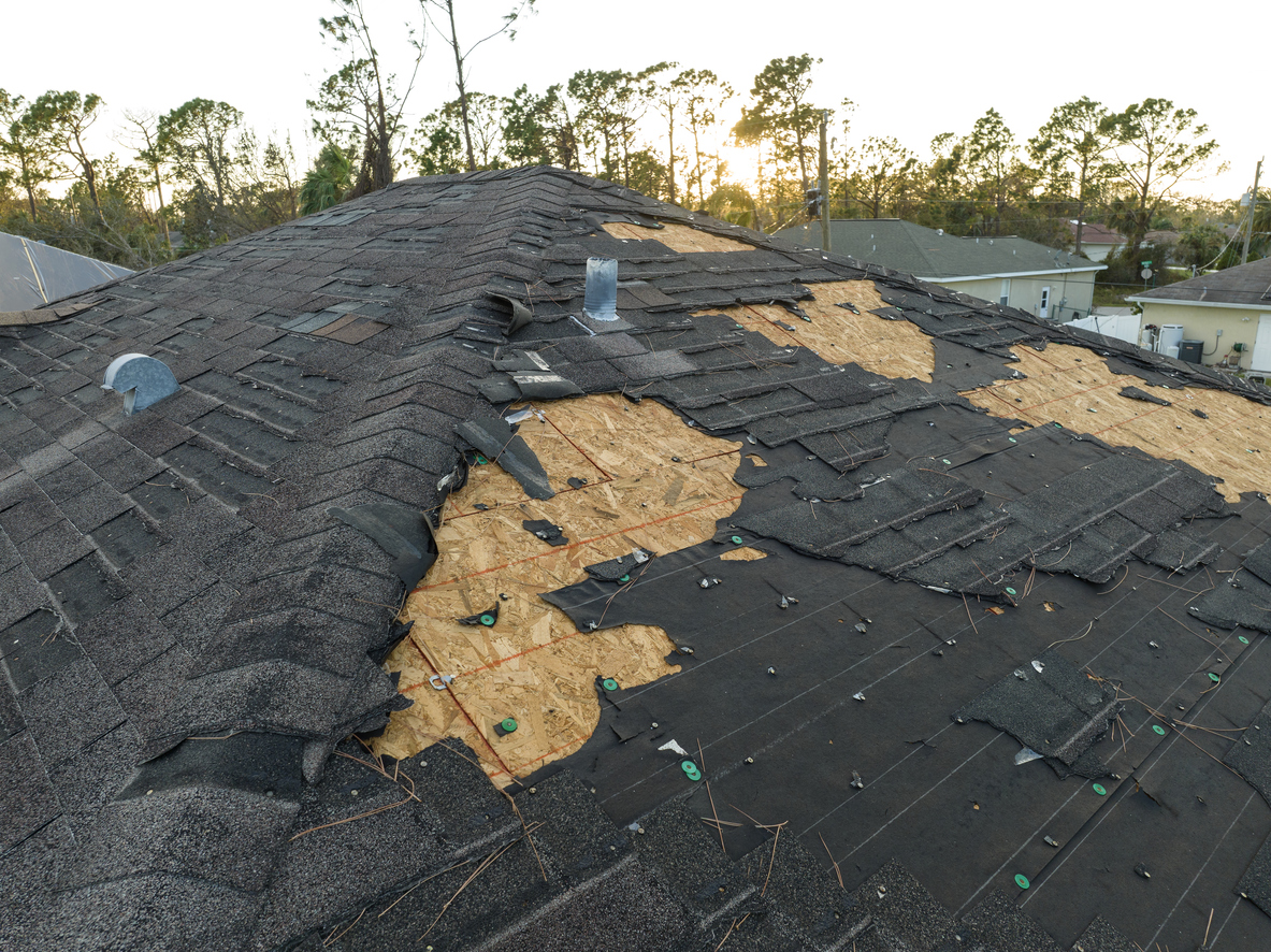 Natural disaster and its consequences. Hurricane Ian destroyed house roof in Florida residential area